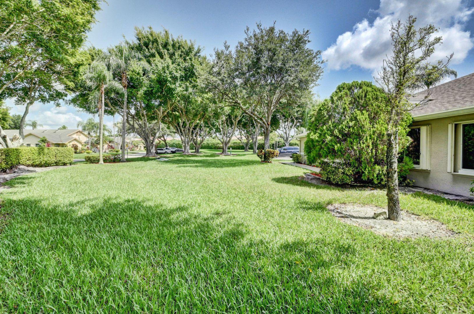 9238 Vineland Court, Unit G Boca Raton, FL 33496 - Photo 28 of 42 a view of a tree in a yard
