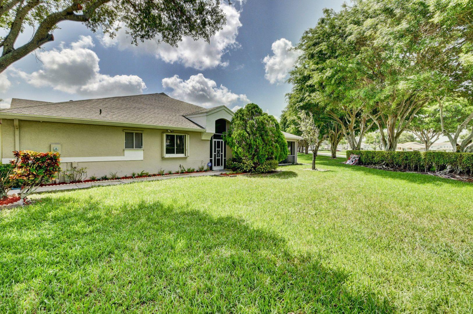 9238 Vineland Court, Unit G Boca Raton, FL 33496 - Photo 29 of 42 a front view of house with yard and trees