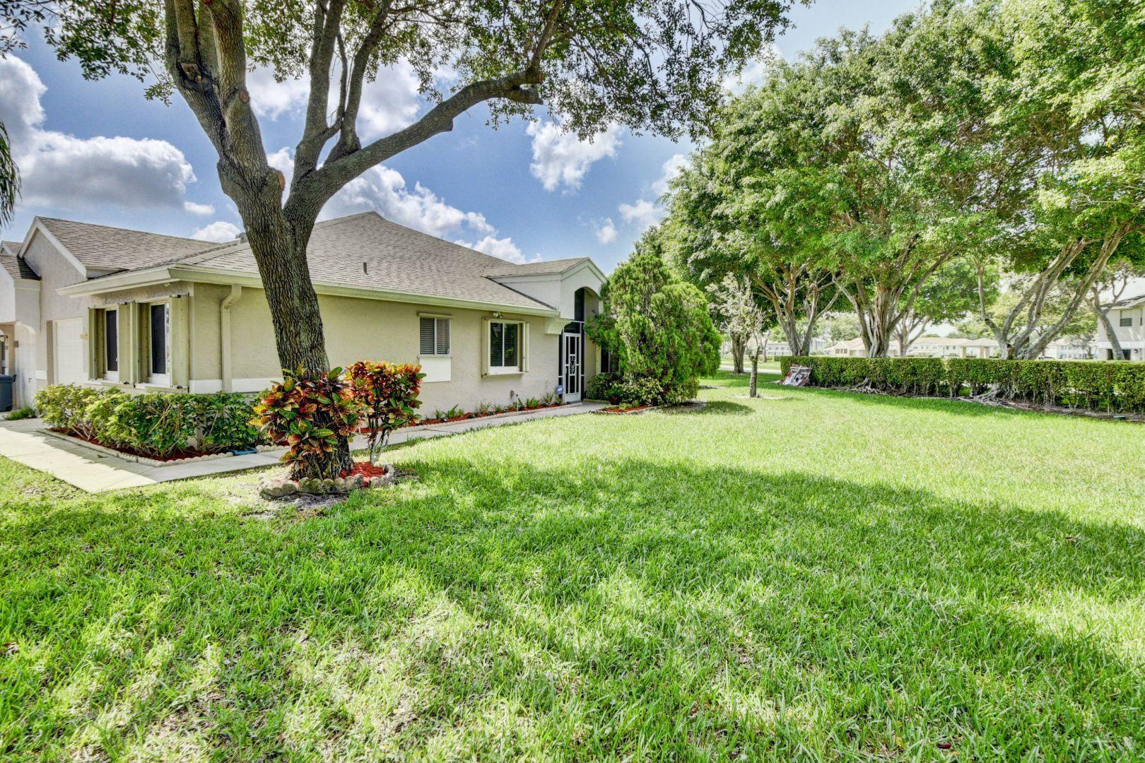 9238 Vineland Court, Unit G Boca Raton, FL 33496 - Photo 30 of 42 a front view of house with yard and green space