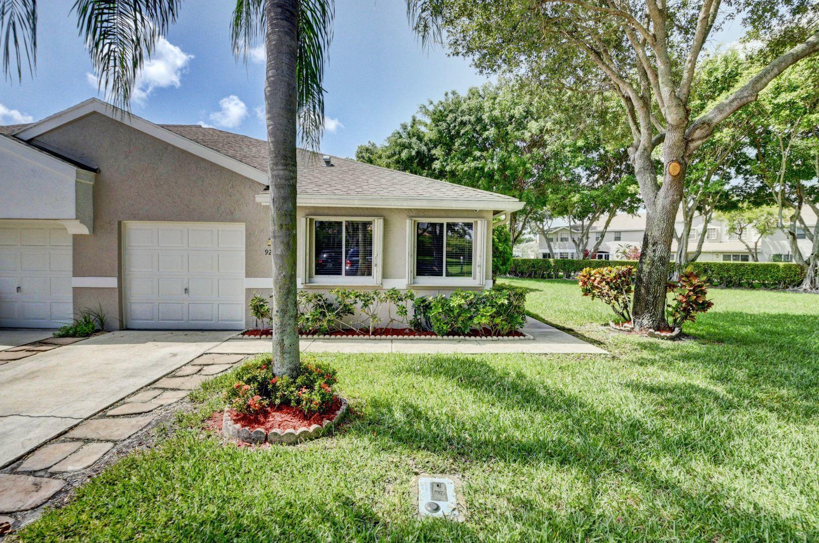 9238 Vineland Court, Unit G Boca Raton, FL 33496 - Photo 3 of 42 a view of a house with a yard and tree s