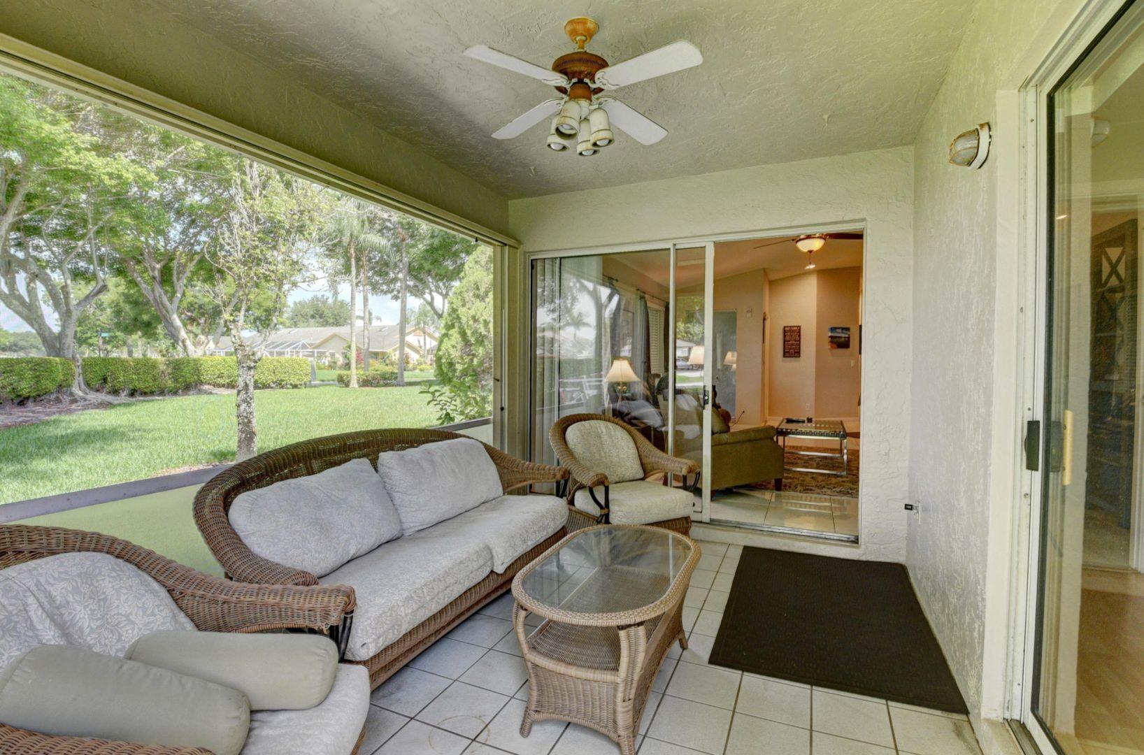 9238 Vineland Court, Unit G Boca Raton, FL 33496 - Photo 38 of 42 a living room with patio furniture and a garden