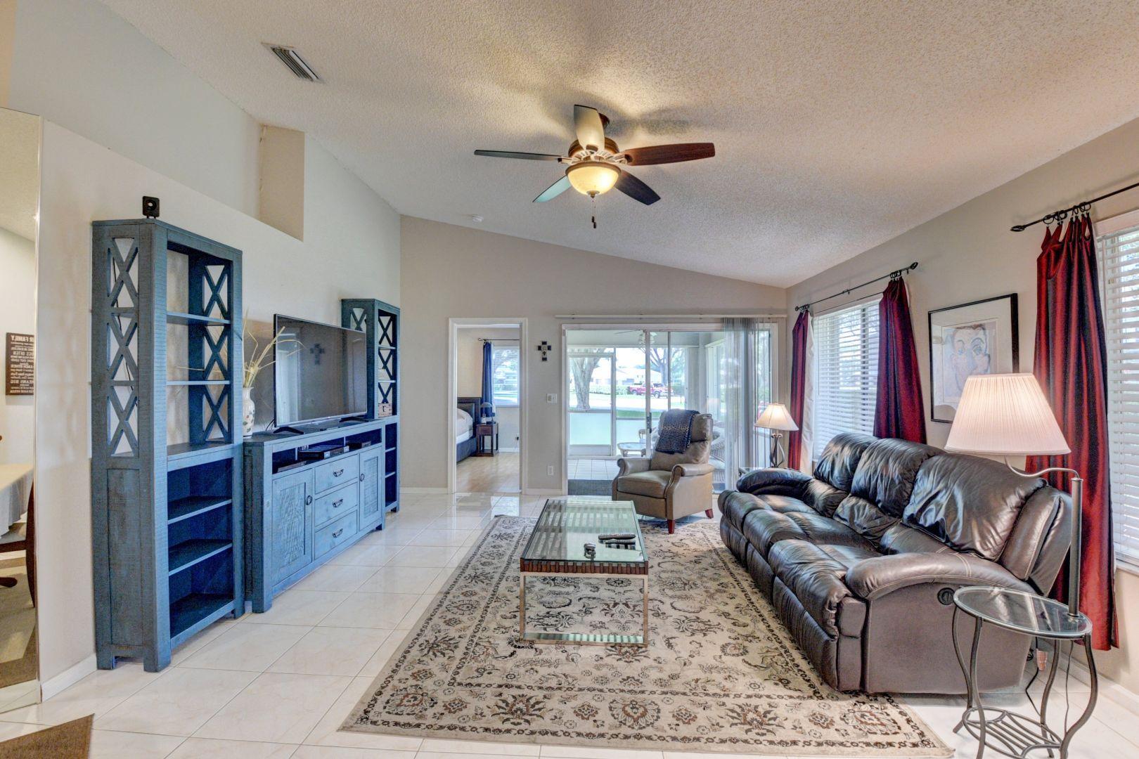 9238 Vineland Court, Unit G Boca Raton, FL 33496 - Photo 5 of 42 a living room with furniture flat screen tv and window