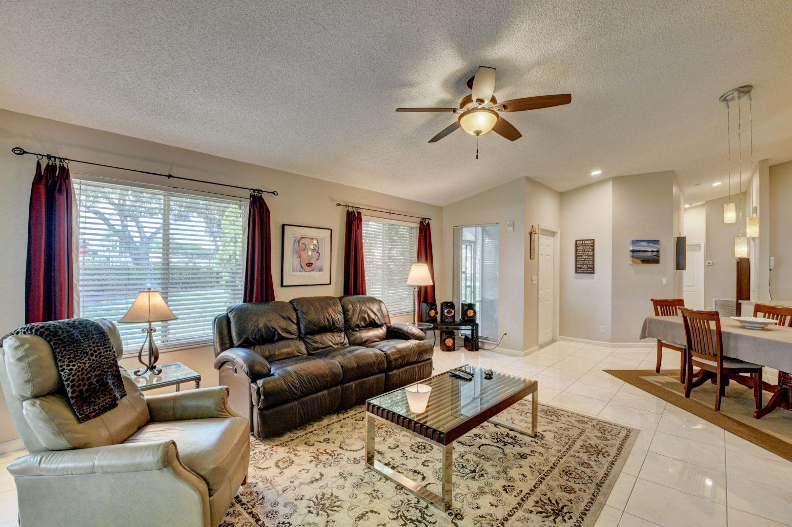 9238 Vineland Court, Unit G Boca Raton, FL 33496 - Photo 7 of 42 a living room with furniture and a large window
