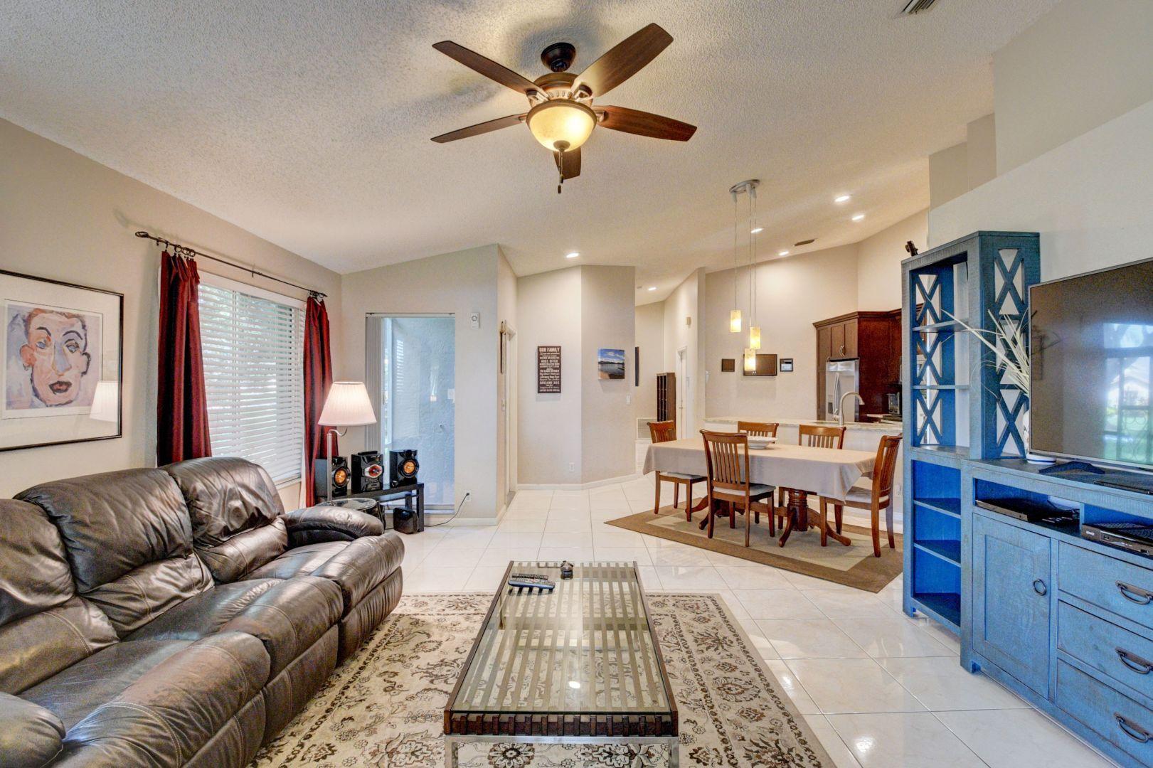 9238 Vineland Court, Unit G Boca Raton, FL 33496 - Photo 8 of 42 a living room with furniture and a flat screen tv