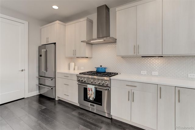 a kitchen with stainless steel appliances white cabinets and a stove