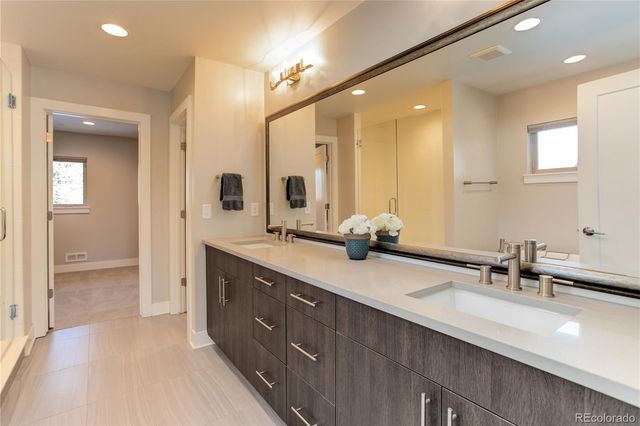 a bathroom with a double vanity sink and a mirror