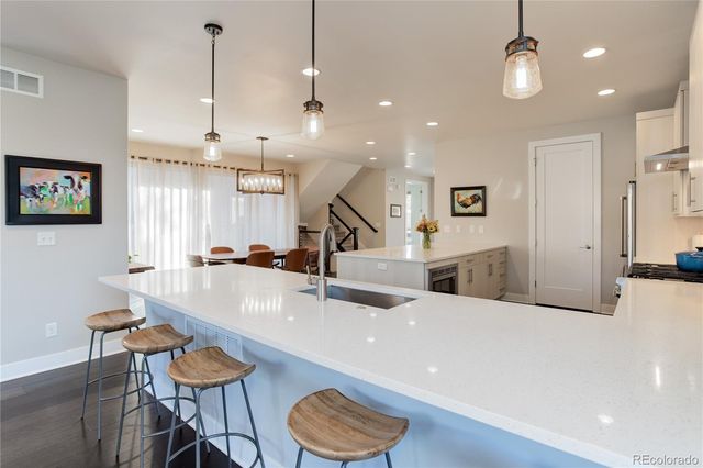 a large kitchen with a table and chairs