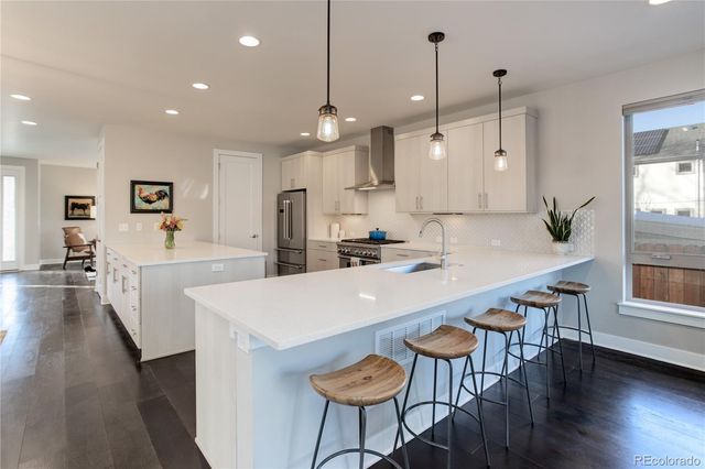a large kitchen with a table and chairs