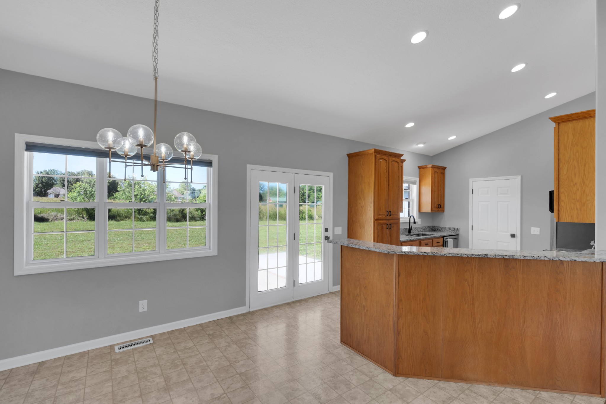 3896 Lynchburg Road Winchester, TN 37398 - Photo 12 of 57 a view of a kitchen with kitchen island a large window cabinets a sink and stainless steel appliances