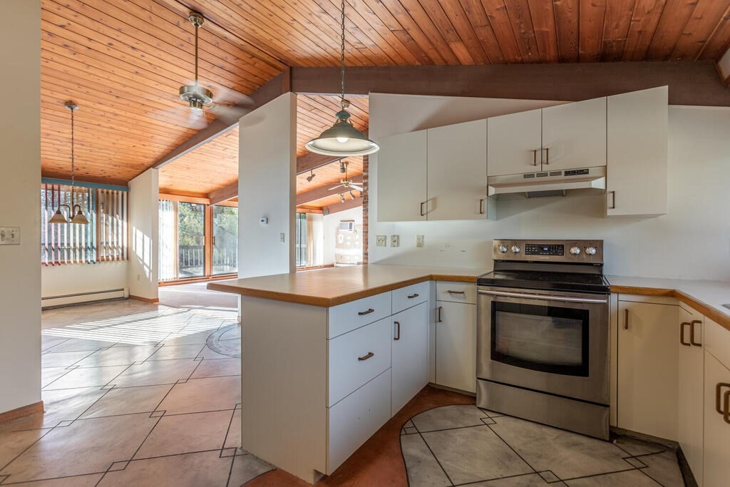 92 Leslie Road Rowley, MA 01969 - Photo 12 of 36 a kitchen with stainless steel appliances granite countertop a stove a sink and a microwave