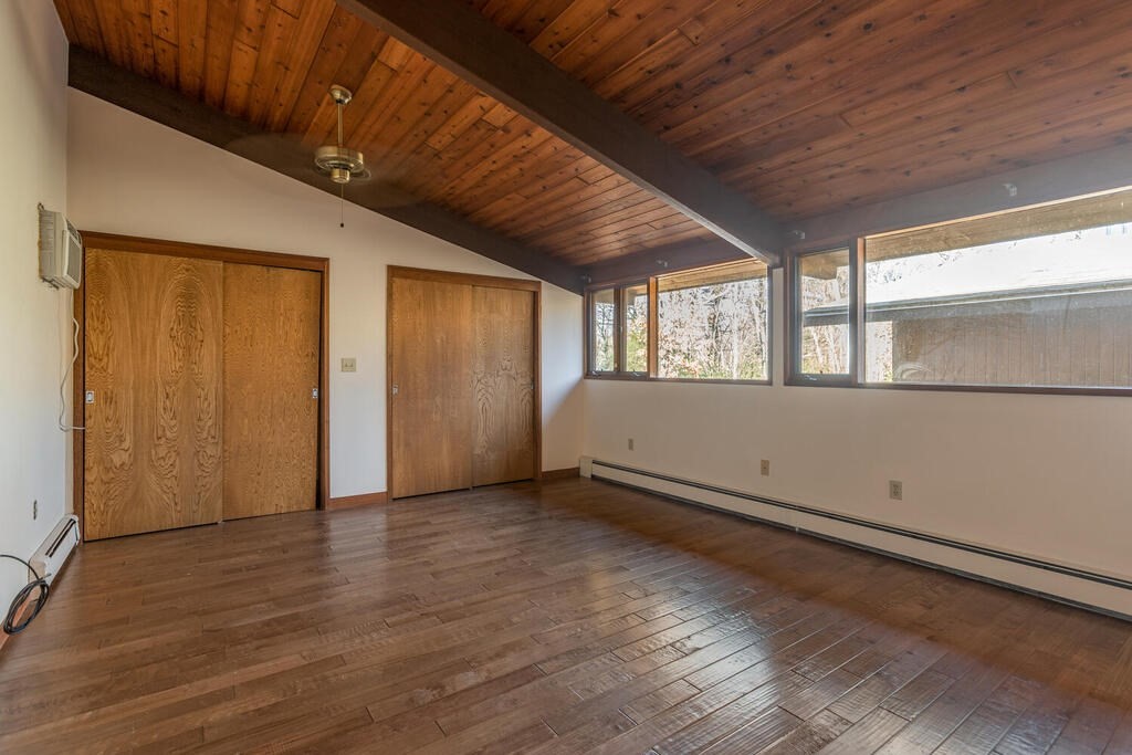 92 Leslie Road Rowley, MA 01969 - Photo 13 of 36 an empty room with wooden floor and windows
