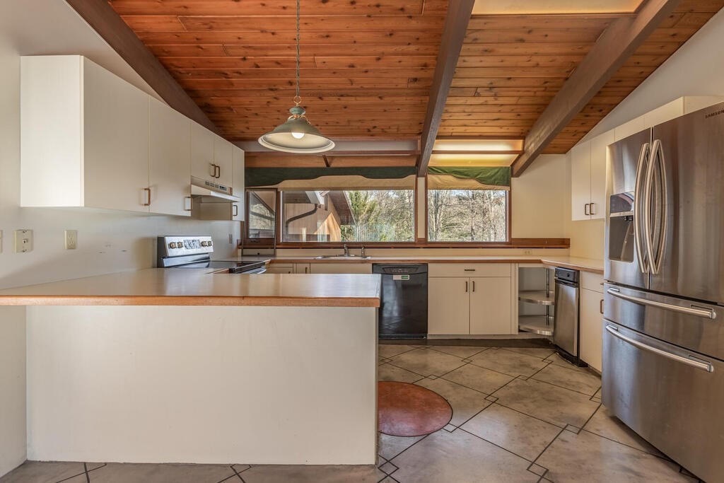 92 Leslie Road Rowley, MA 01969 - Photo 9 of 36 a kitchen with a stove a refrigerator and dishwasher with wooden floor