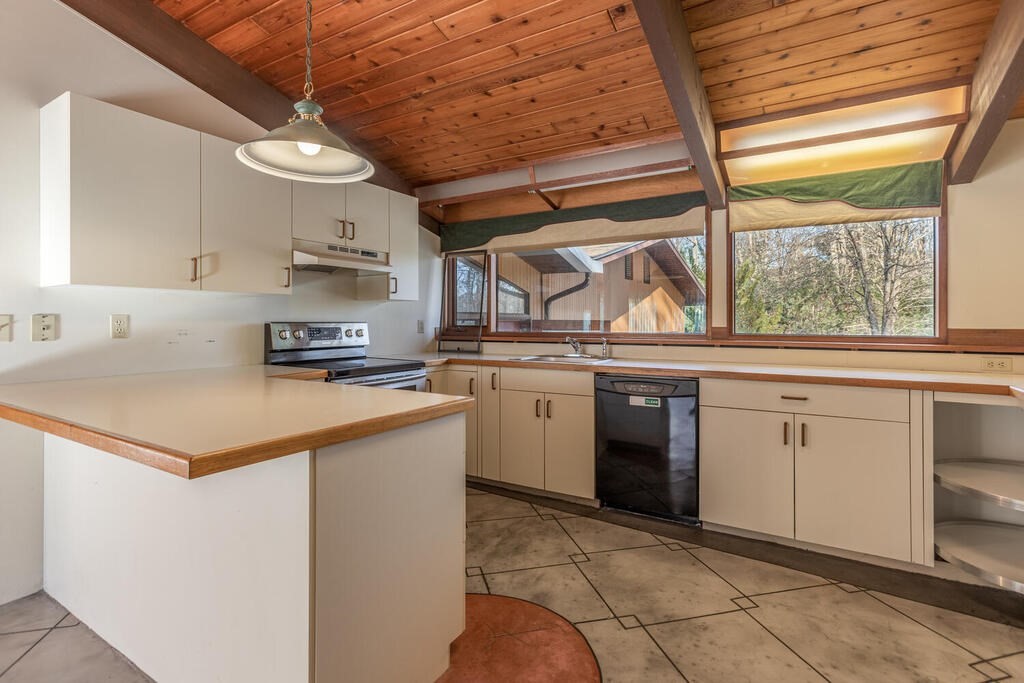 92 Leslie Road Rowley, MA 01969 - Photo 10 of 36 a kitchen with a stove a sink and a refrigerator