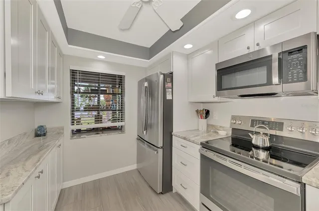 a kitchen with stainless steel appliances a refrigerator sink and microwave