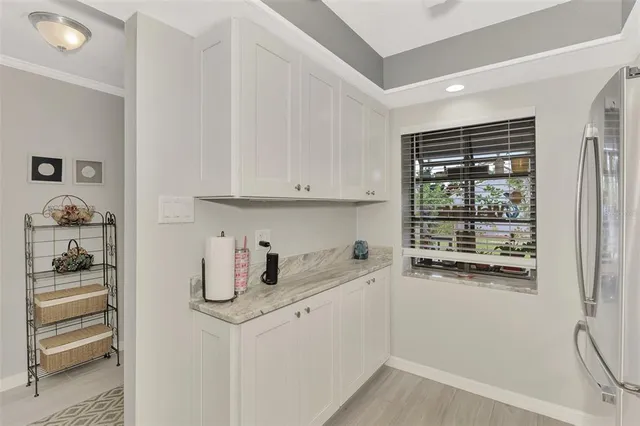 a kitchen with a refrigerator and cabinets