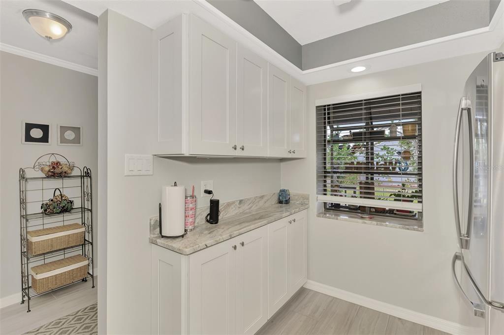 285 Mission Trail West, Unit B Venice, FL 34285 - Photo 16 of 49 a kitchen with a refrigerator and cabinets