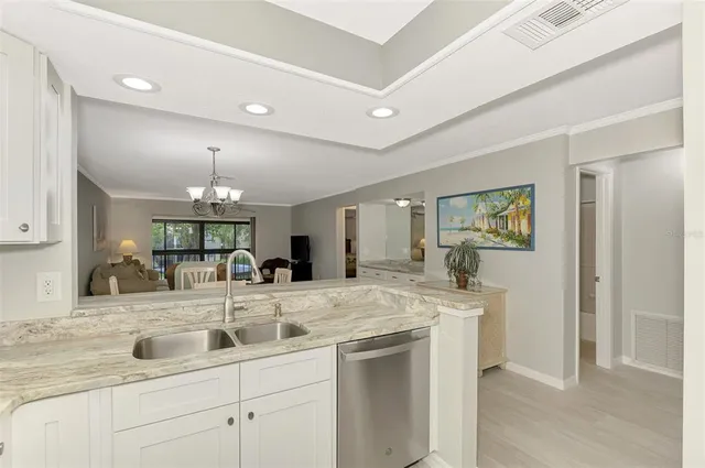 a view of a kitchen counter space a sink and appliances