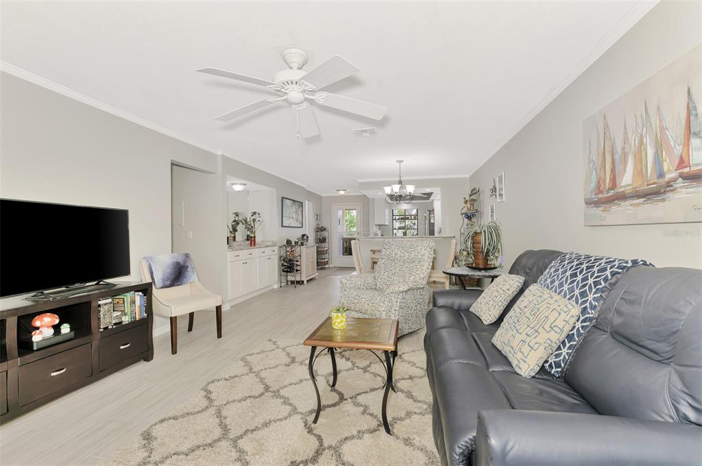 285 Mission Trail West, Unit B Venice, FL 34285 - Photo 28 of 49 a living room with furniture and a flat screen tv