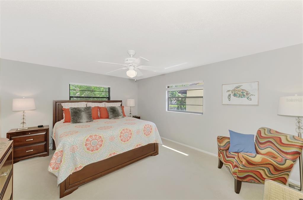 285 Mission Trail West, Unit B Venice, FL 34285 - Photo 29 of 49 a bedroom with a bed and lamp