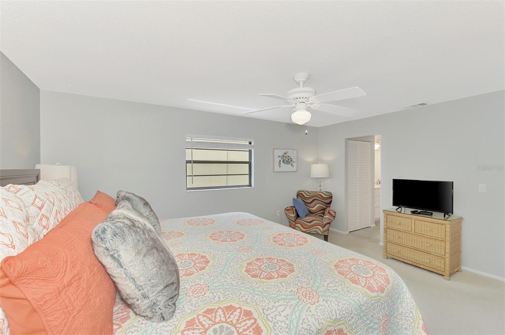 285 Mission Trail West, Unit B Venice, FL 34285 - Photo 32 of 49 a bedroom with a bed and a tv
