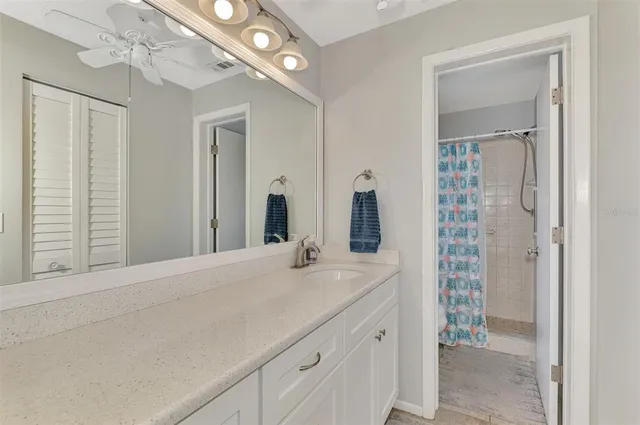 a spacious bathroom with a double vanity sink and a mirror