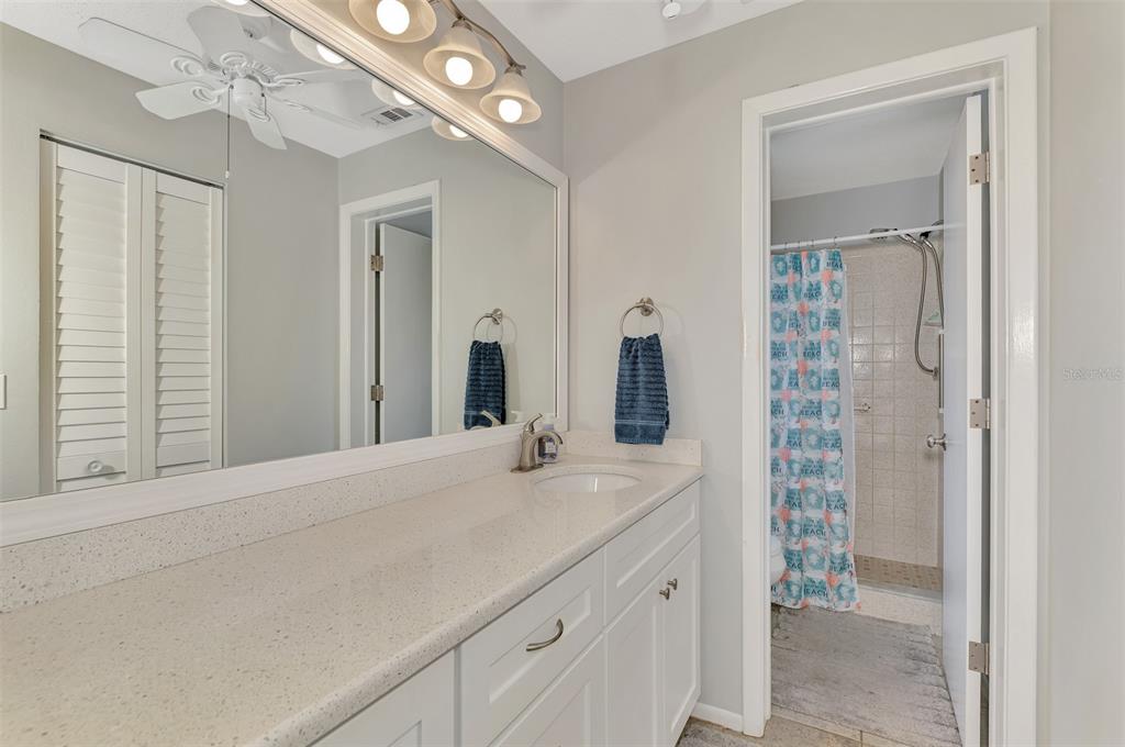 285 Mission Trail West, Unit B Venice, FL 34285 - Photo 33 of 49 a spacious bathroom with a double vanity sink and a mirror