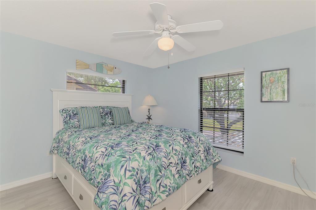 285 Mission Trail West, Unit B Venice, FL 34285 - Photo 35 of 49 a bedroom with a large bed and a window