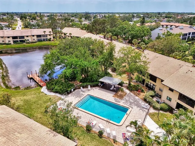 an aerial view of a house with a garden and lake view