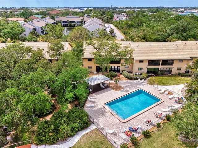 an aerial view of a house with garden space and lake view