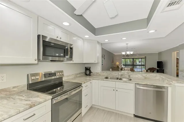 a kitchen with a sink a stove and microwave