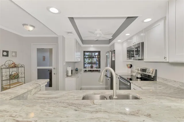 a view of a livingroom with kitchen and furniture