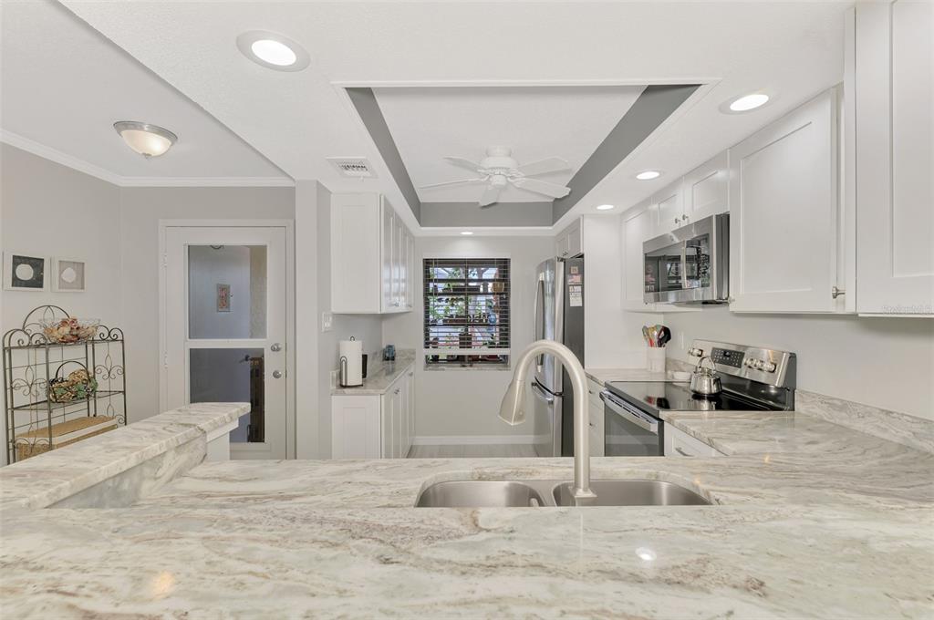 285 Mission Trail West, Unit B Venice, FL 34285 - Photo 10 of 49 a view of a livingroom with kitchen and furniture