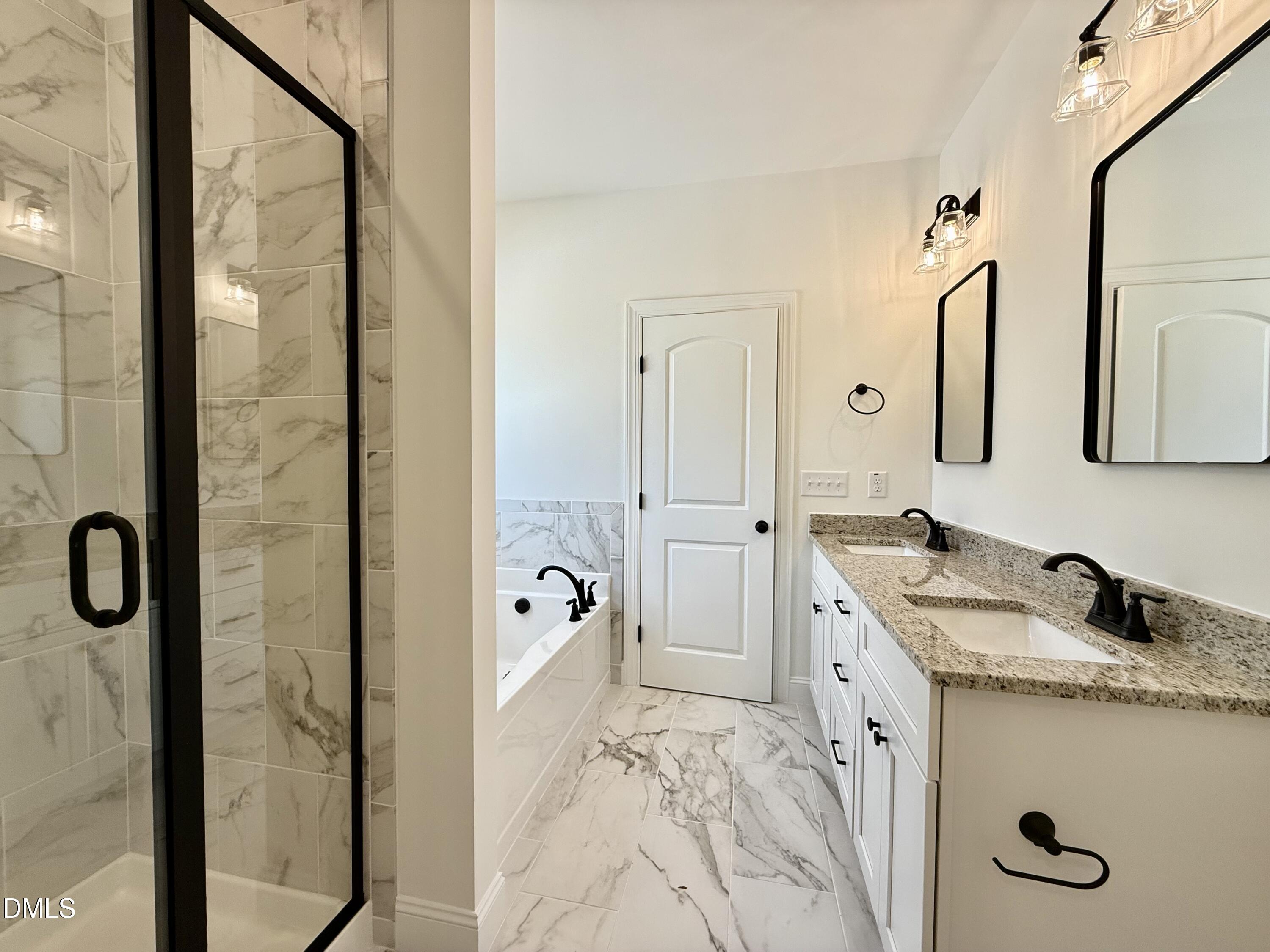 10300 Stallings Road Spring Hope, NC 27882 - Photo 24 of 36 a bathroom with a granite countertop sink mirror and shower