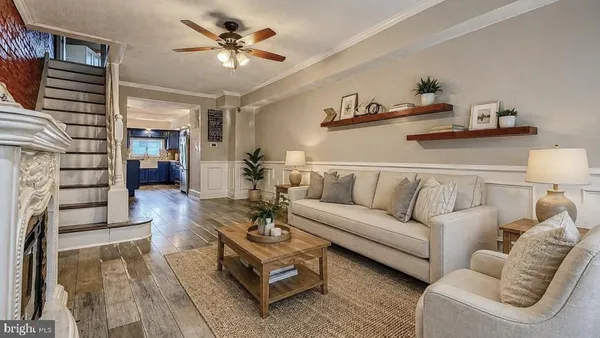 a kitchen with stainless steel appliances granite countertop a refrigerator a sink dishwasher a stove and white cabinets with wooden floor