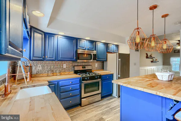 a kitchen with stainless steel appliances granite countertop a stove and a sink