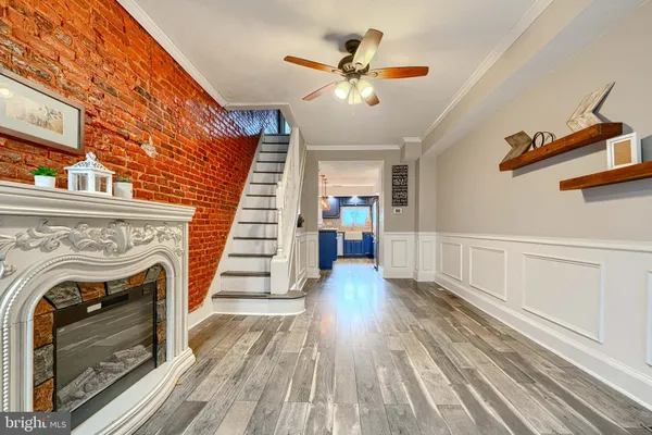 a view of a livingroom with wooden floor and a fireplace