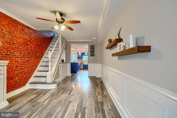 a view of entryway and hall with wooden floor