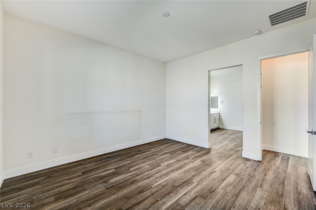 8197 Riley Love Street Las Vegas, NV 89139 - Photo 26 of 48 A well-lit room with resilient plank flooring and a clear pathway to an adjacent private bath.
