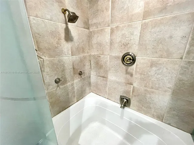 a view of walk in closet with wooden floor and furniture