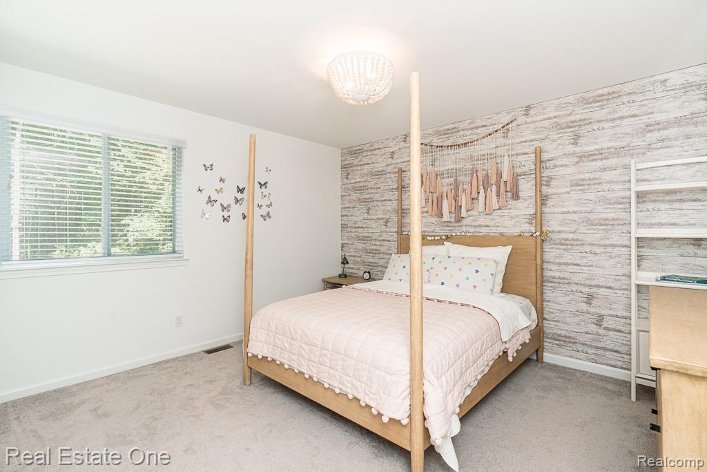 201 Beechview Drive Rochester, MI 48306 - Photo 32 of 49 Recessed lighting, wood-finish accent wall, light-toned carpeting, and a large window with blinds
