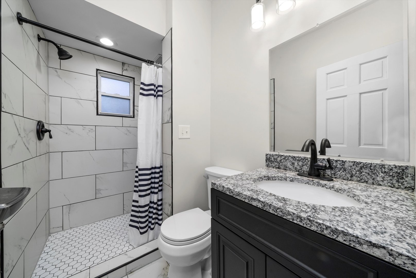 3227 South Wells Street, Unit COACHHOUSE Chicago, IL 60616 - Photo 11 of 20 a bathroom with a granite countertop toilet sink and mirror