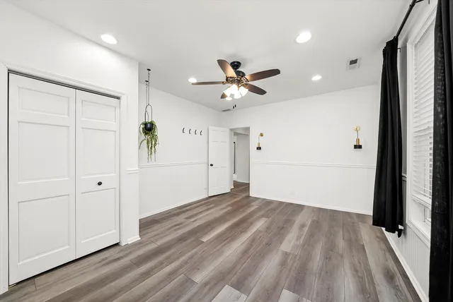 wooden floor in an empty room with a window