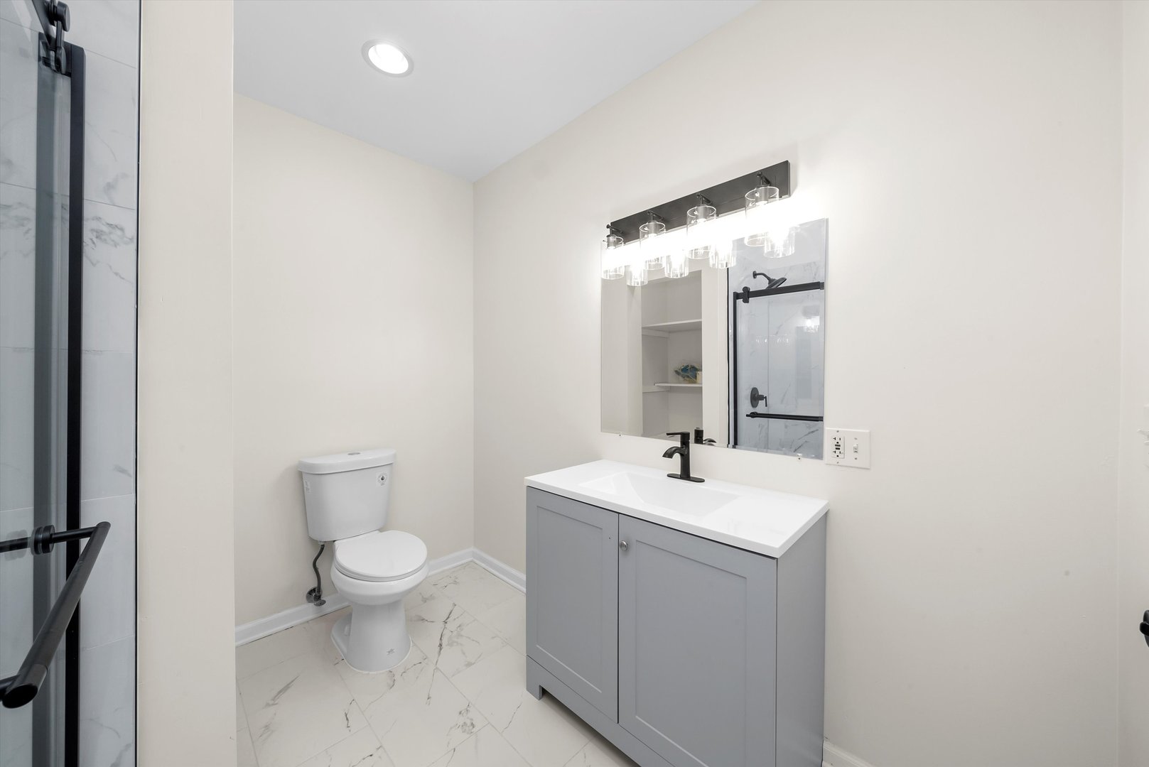 3227 South Wells Street, Unit COACHHOUSE Chicago, IL 60616 - Photo 16 of 20 a bathroom with a toilet a sink and mirror