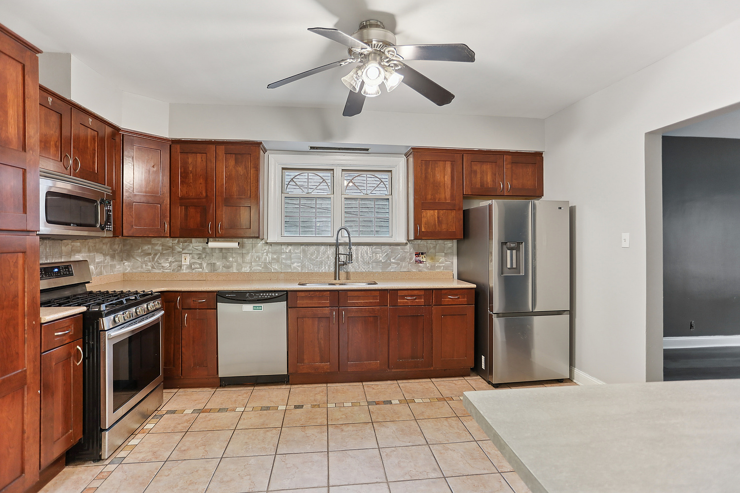 3227 South Wells Street, Unit COACHHOUSE Chicago, IL 60616 - Photo 4 of 18 a kitchen with stainless steel appliances granite countertop a refrigerator oven a sink dishwasher and a refrigerator