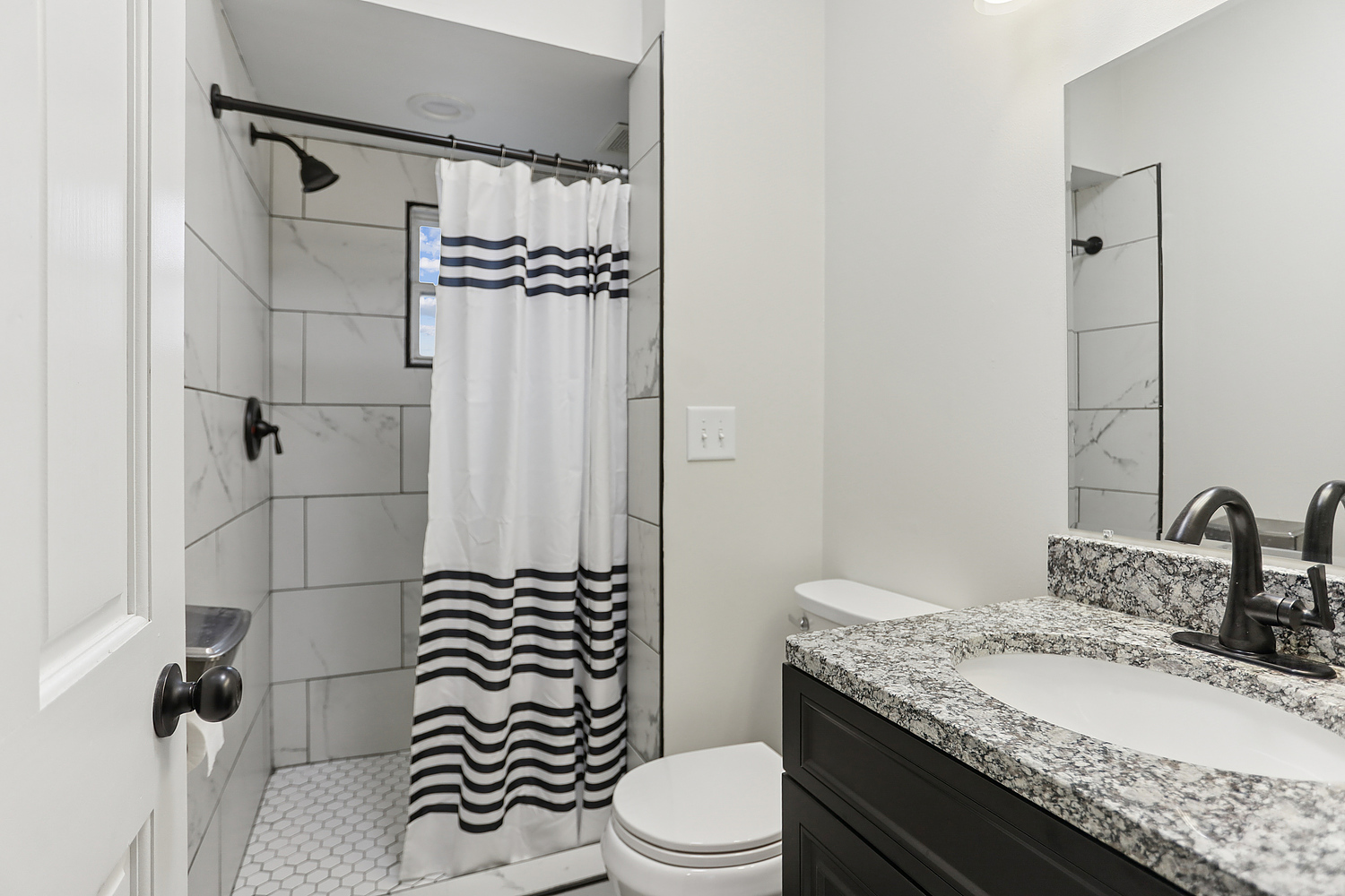 3227 South Wells Street, Unit COACHHOUSE Chicago, IL 60616 - Photo 6 of 18 a bathroom with a granite countertop sink toilet mirror and shower