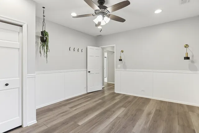 a view of a room with a ceiling fan and a fan