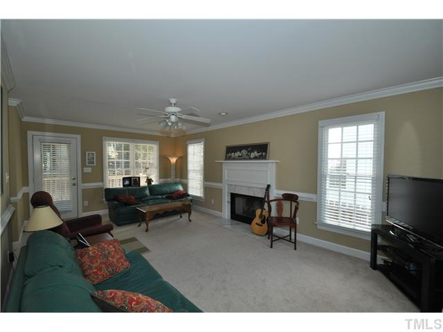 2901 Dahlgreen Road Raleigh, NC 27615 - Photo 2 of 17 a living room with furniture a fireplace and a flat screen tv