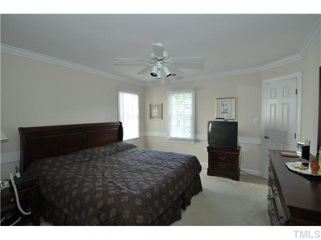 2901 Dahlgreen Road Raleigh, NC 27615 - Photo 9 of 17 a bedroom with a bed and a chandelier
