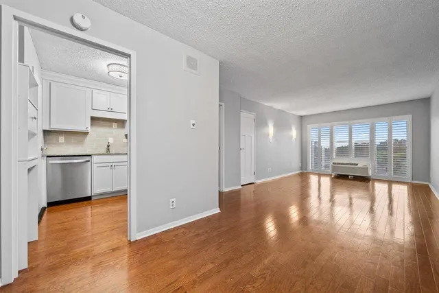 a view of a kitchen with wooden floor and a kitchen
