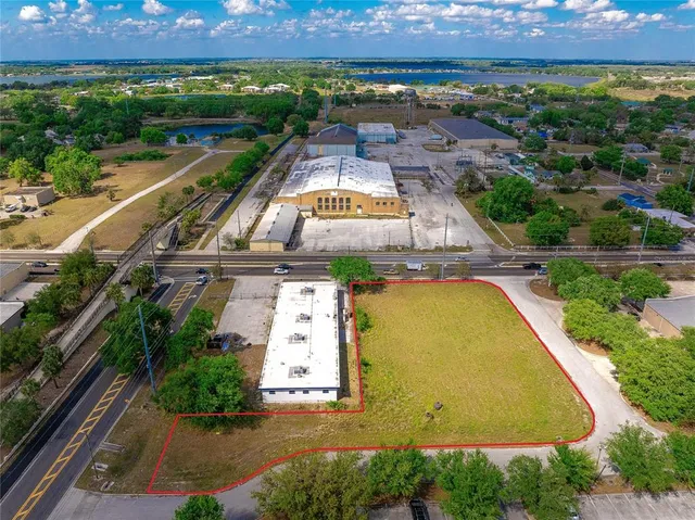 an aerial view of residential houses with outdoor space and swimming pool